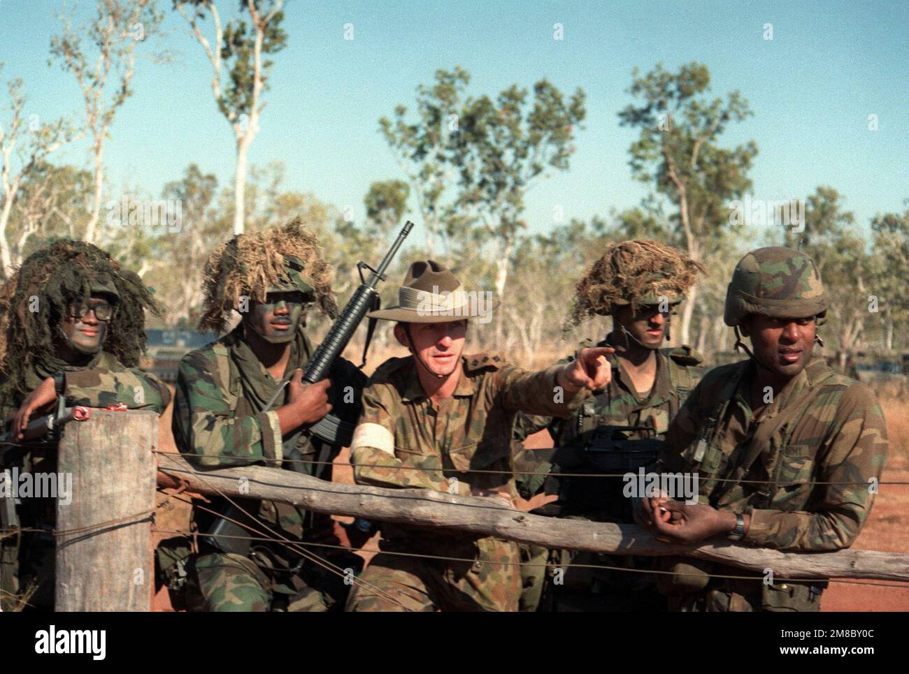 An Australian army captain briefs four scouts from 4th Bn