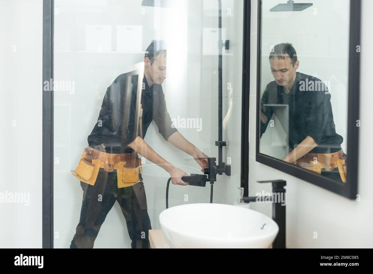 Plumber installing a shower cabin in bathroom stock photo alamy