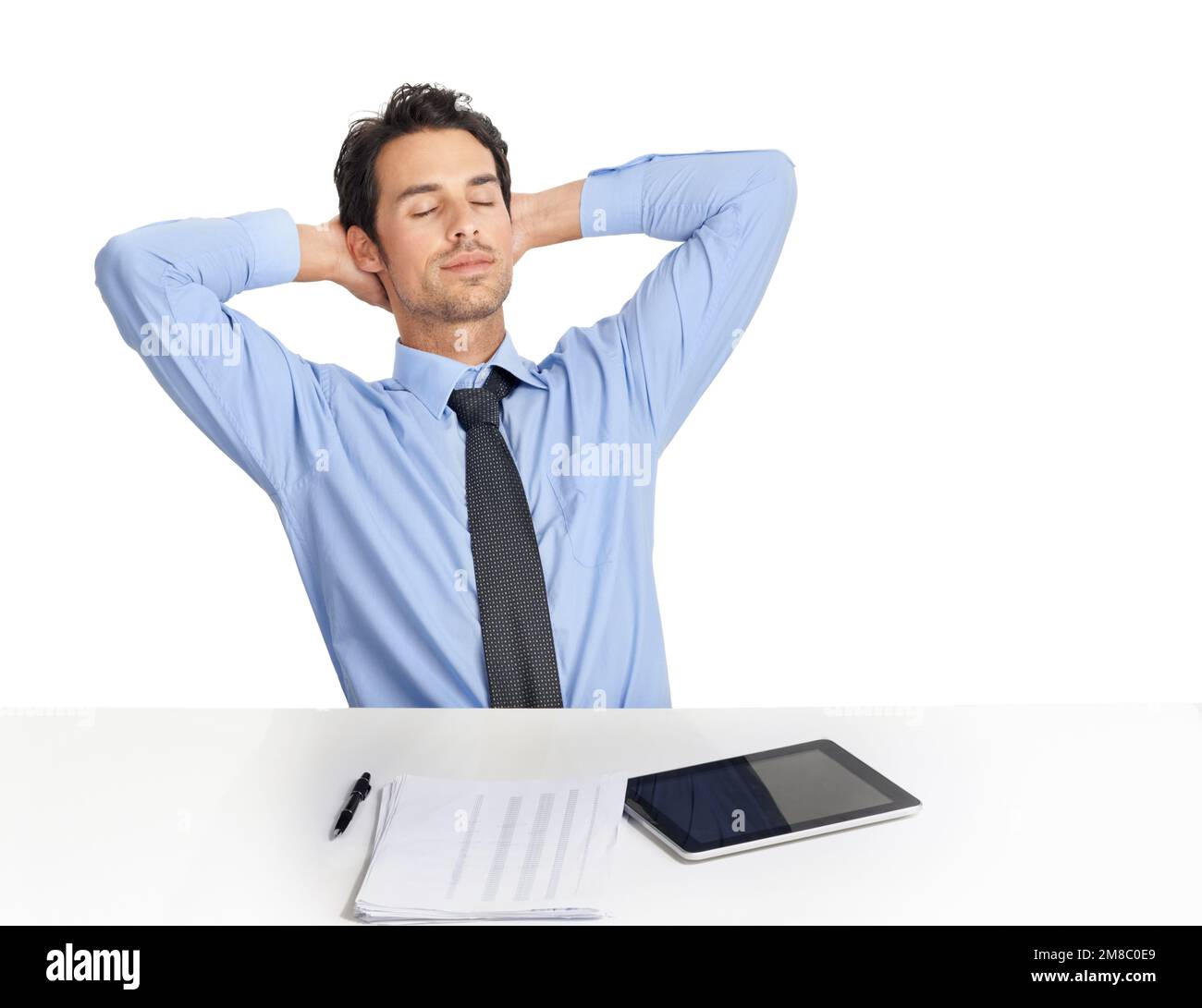 Businessman, tablet and tired rest at desk in studio for lunch break, nap or daydream after accounting planning, finance analysis or sales growth. Man Stock Photo