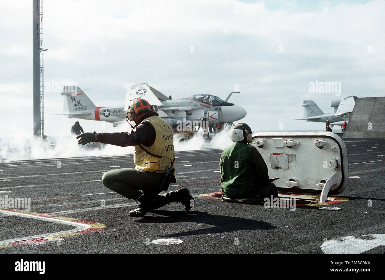 A catapult officer maintains his position following the launch of an ...