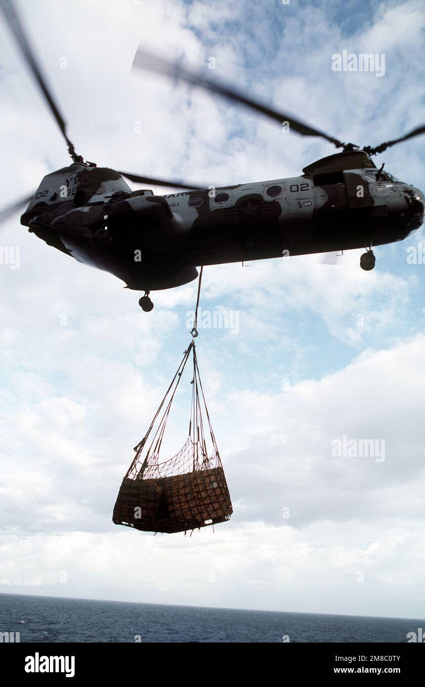 A CH-46E Sea Knight helicopter of Marine Heavy Helicopter Squadron 163 (HMM-163) carries supplies on a sling during the joint Thai/U.S. exercise Thalay Thai '89. Subject Operation/Series: THALAY THAI '89 Country: Thailand (THA) Stock Photo