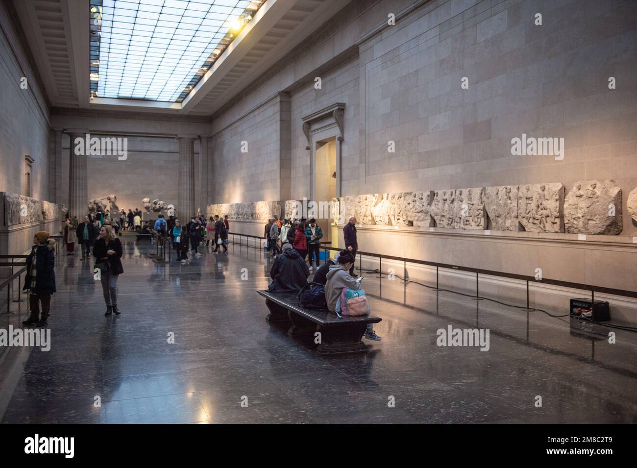 Visitors view the Parthenon Marbles, also known as the Elgin Marbles, at the British Museum in London on January 12, 2023. - The ancient sculptures we Stock Photo