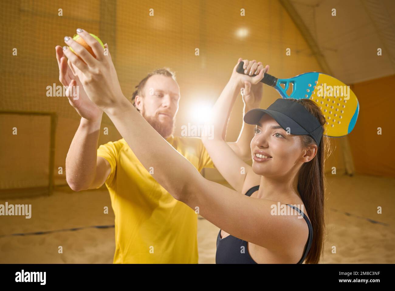 Coach touches raised hands of tennis player with racket and ball Stock ...