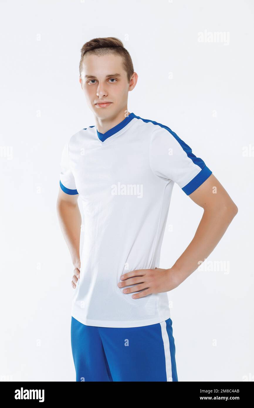 Football player in white and blue uniform against a white background Stock Photo