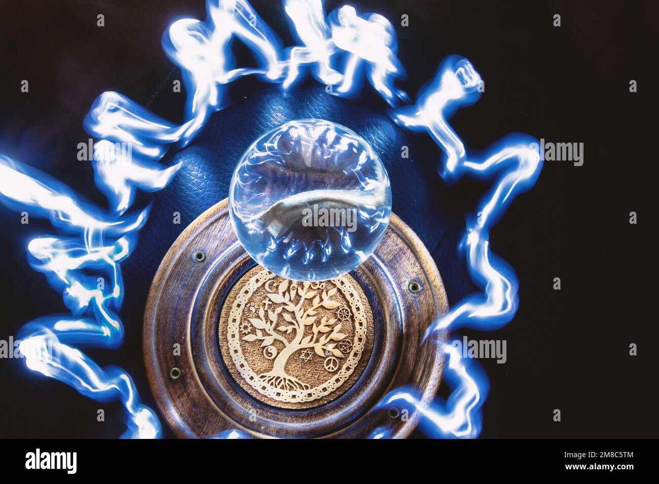 Lensball illuminated with light painting, the tree of life symbol under the lensball Stock Photo