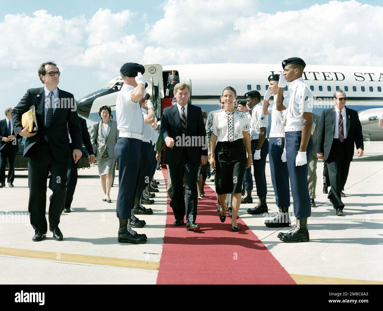 An Air Force honor guard salutes as Vice President J. Danforth Quayle and Marilyn Quayle arrive on base for a visit. Base: Kadena Air Base State: Okinawa Country: Japan (JPN) Stock Photo