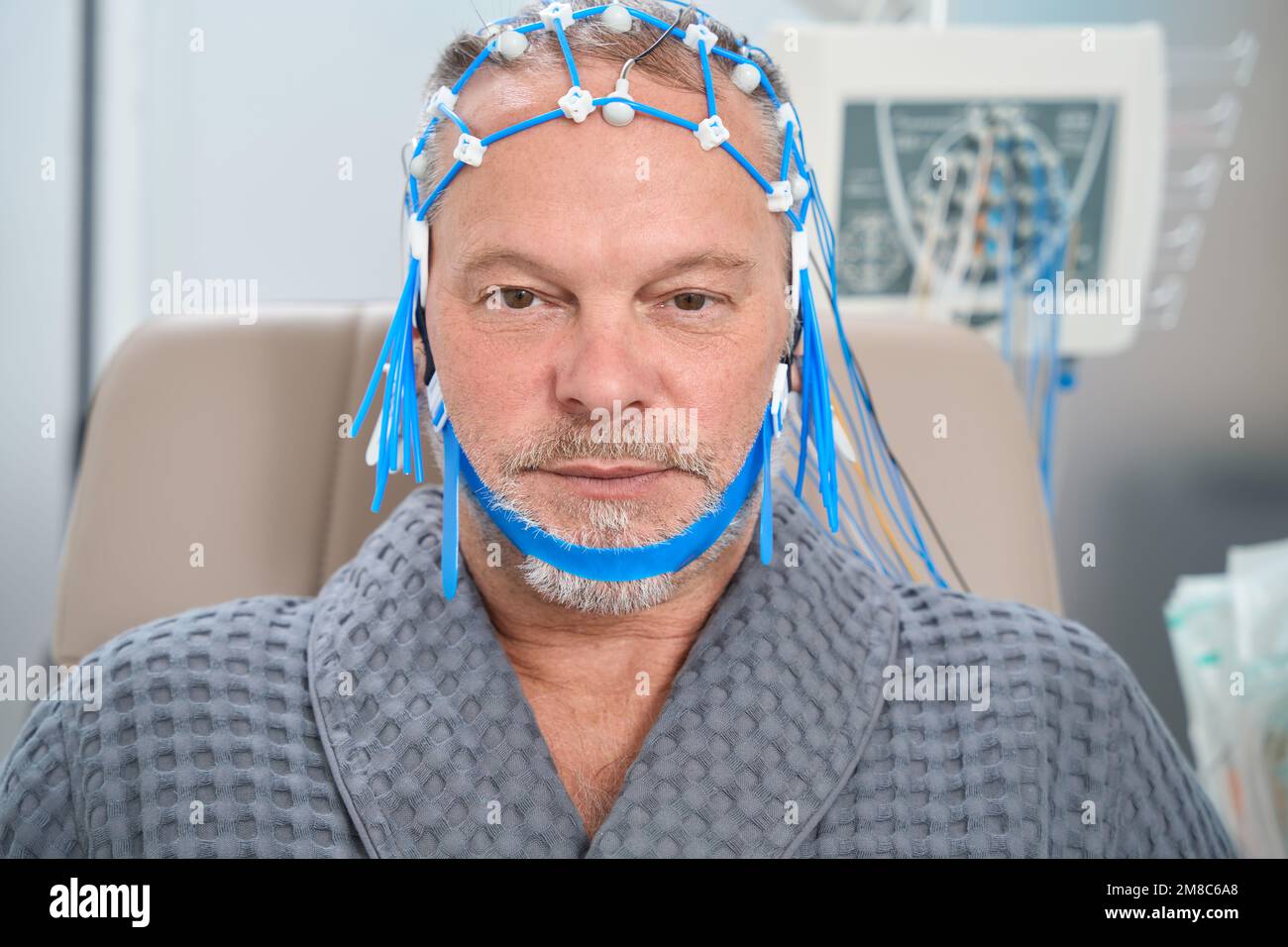 Patient has grid of electrodes for encephalography on his head Stock