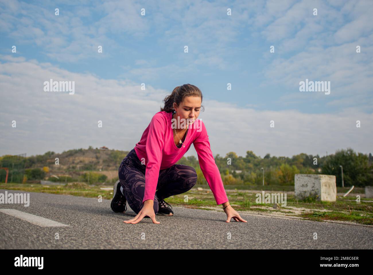 Attractive and beautiful girl is concetrating before her run in the morning Stock Photo