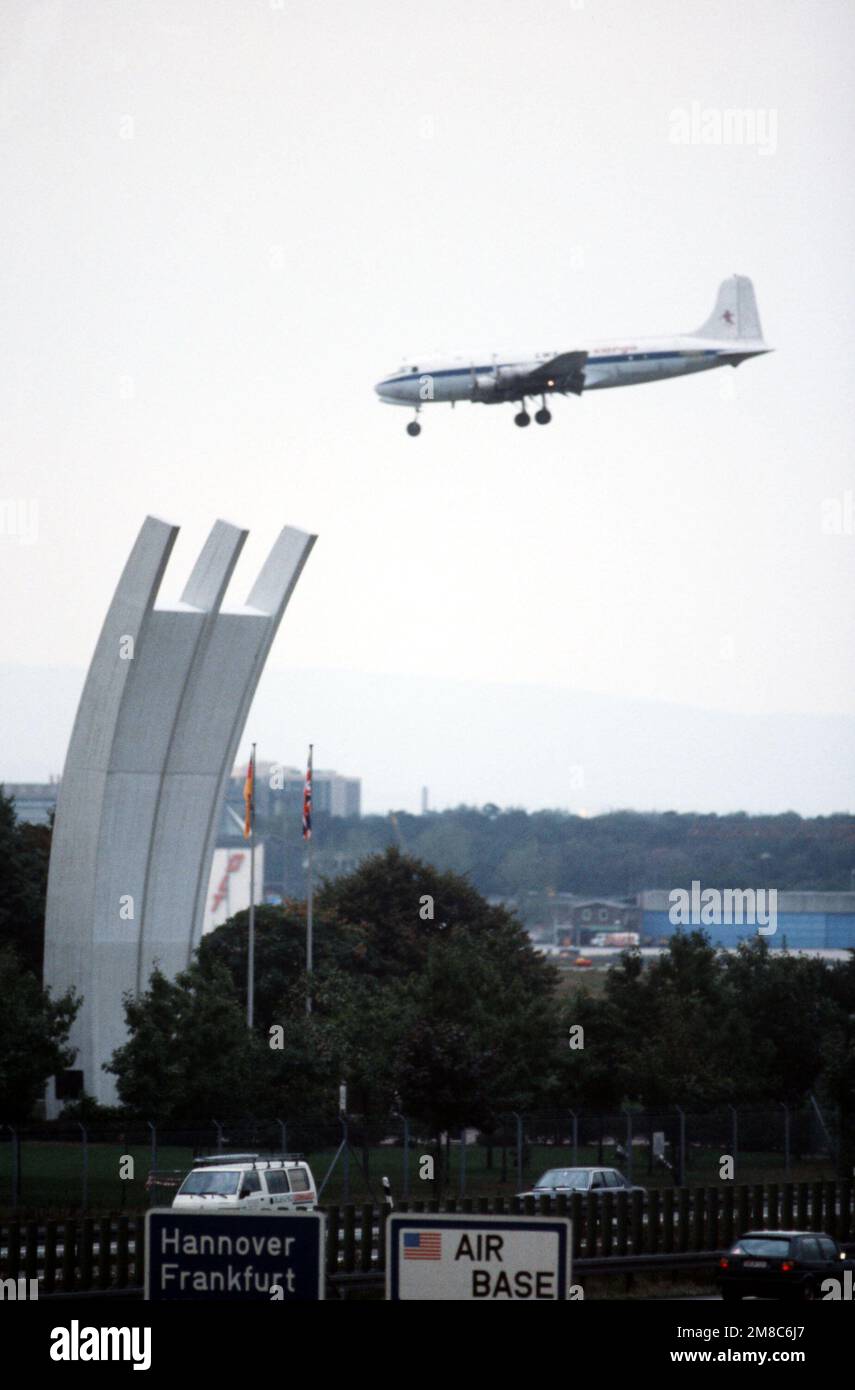 A C-54 aircraft flies over the Luftbruecke Memorial as it arrives on ...