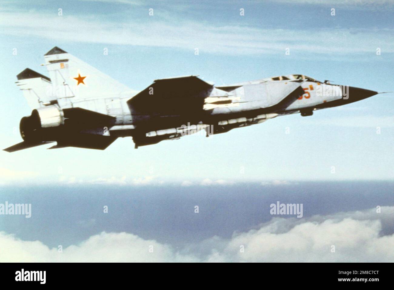 An air-to-air right side view of a Soviet MiG-31 Foxhound aircraft. Country: Unknown Stock Photo