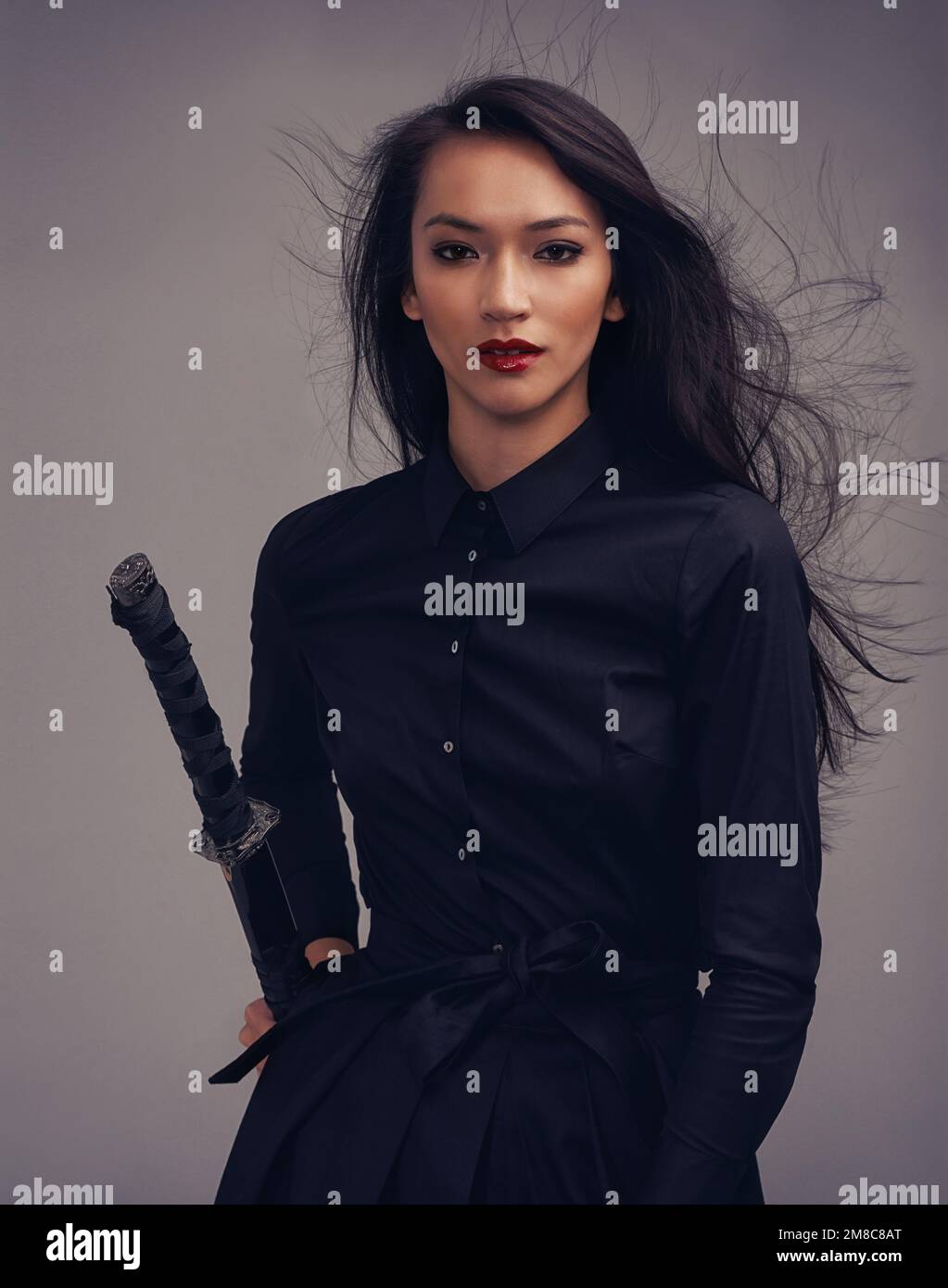 Fashion, beauty portrait and warrior woman art with sword to fight for power, cosplay and fantasy. Strong asian female from Japan in black for makeup Stock Photo