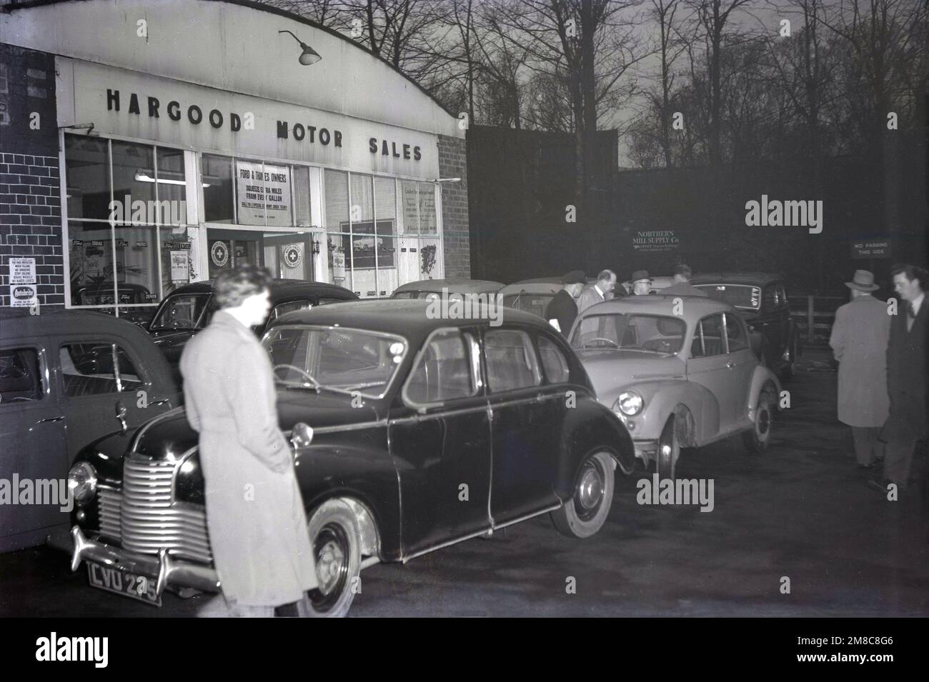 1950s, historical, evening time and men outside Hargood Motor Sales