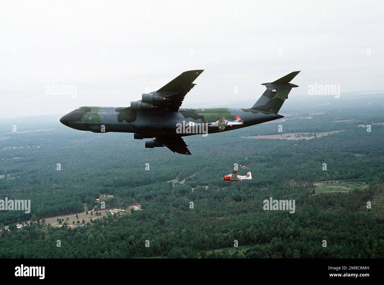A Pilatus PC-9 aircraft, center foreground, and an Army T-28B Tojan ...