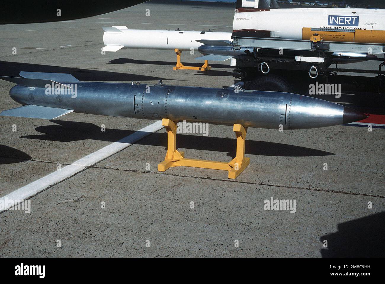 A view of a B61 nuclear bomb trainer, center, being shown at a static