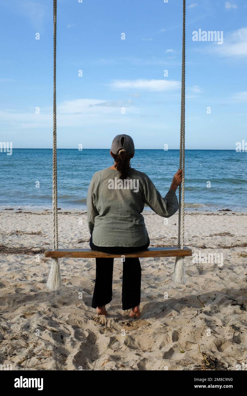 Woman looking at the ocean Stock Photo