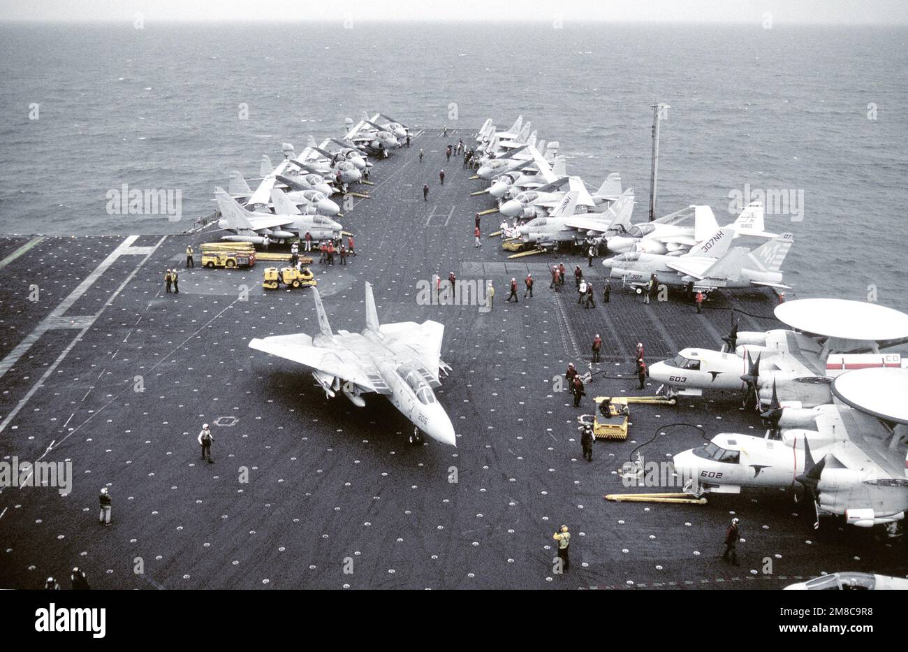 Various aircraft line the flight deck of the nuclear-pwoered