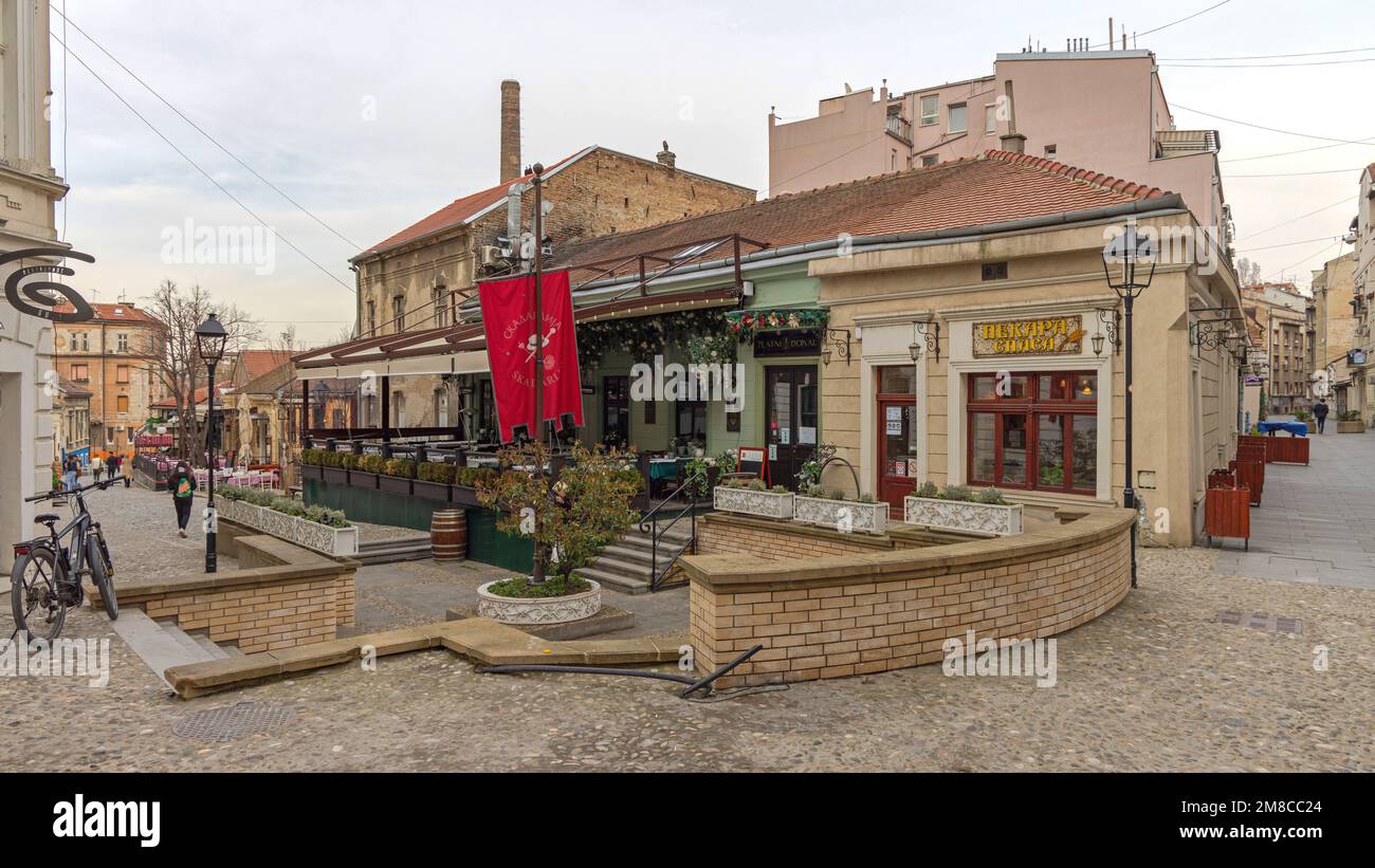 Belgrade, Serbia - March 15, 2022: Red Flag Pole Landmark at Vintage Street Bohemian Skadarlija in Old Town. Stock Photo