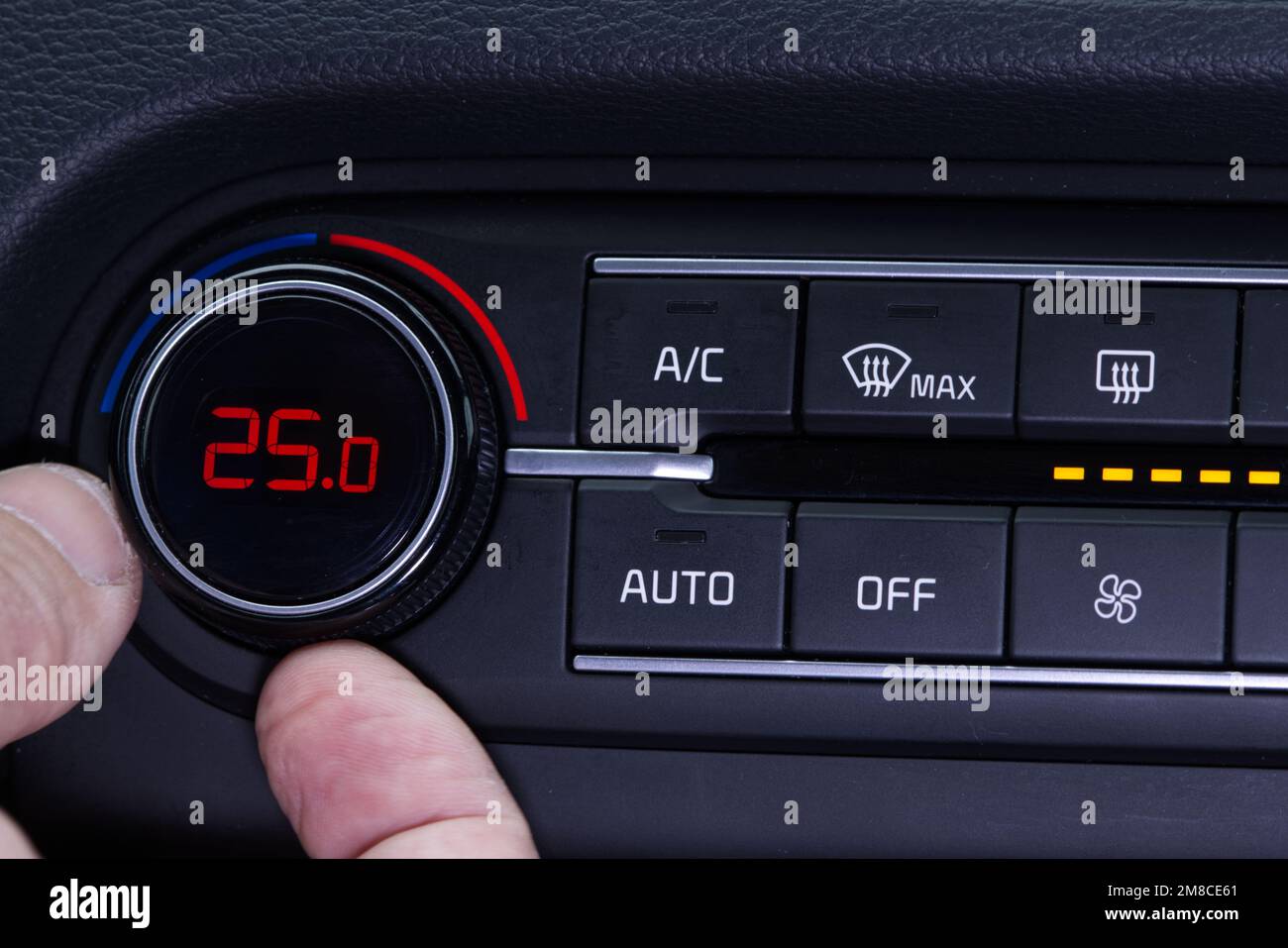 Set up air conditioner in the car. Hand turns air conditioner ring