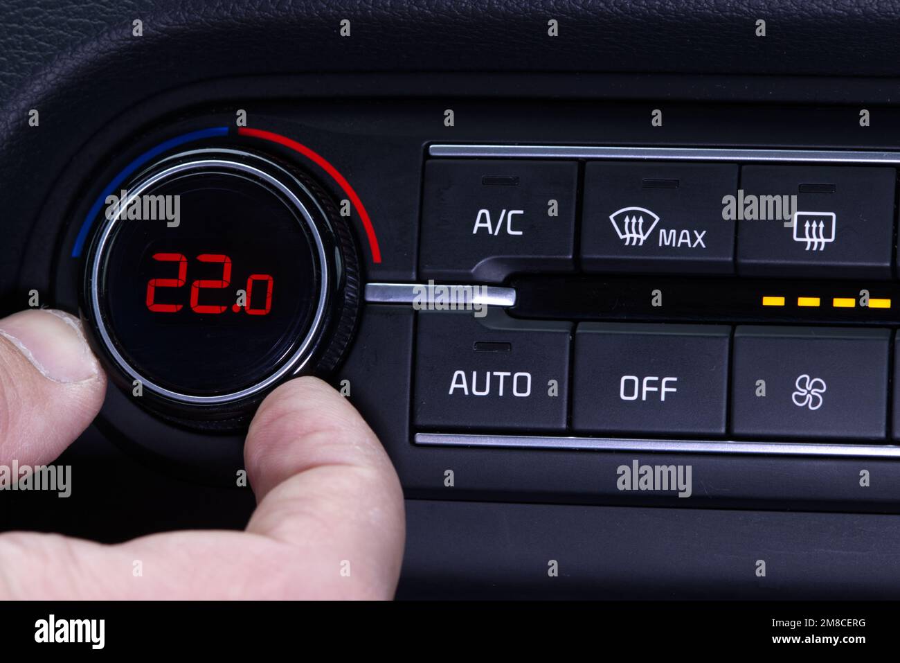 Set up air conditioner in the car. Hand turns air conditioner ring