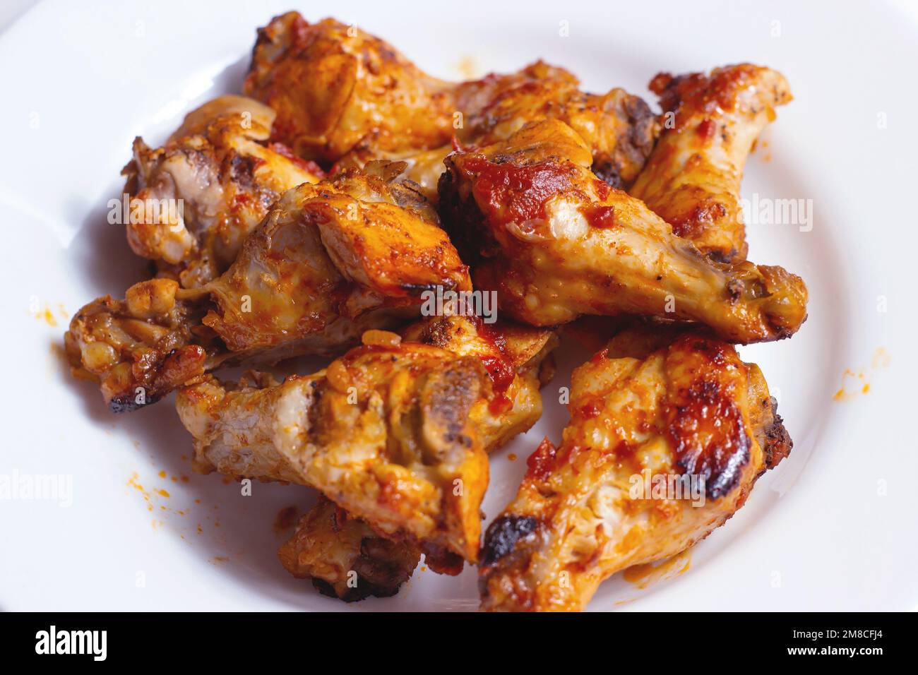 Fried chicken legs for dinner on white plate background close up. Stock Photo