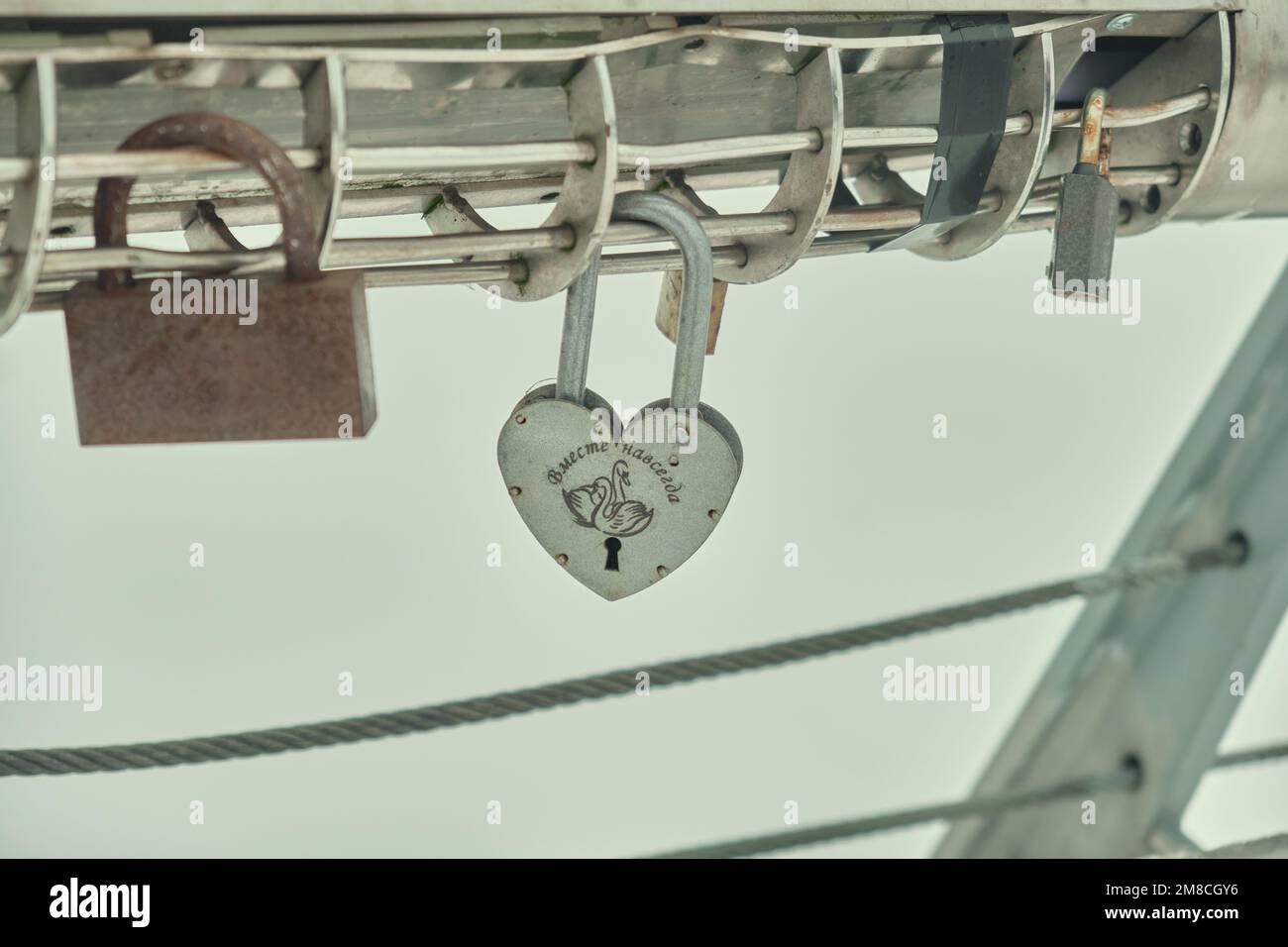 Frozen padlocks are installed along the bridge path and the love locks