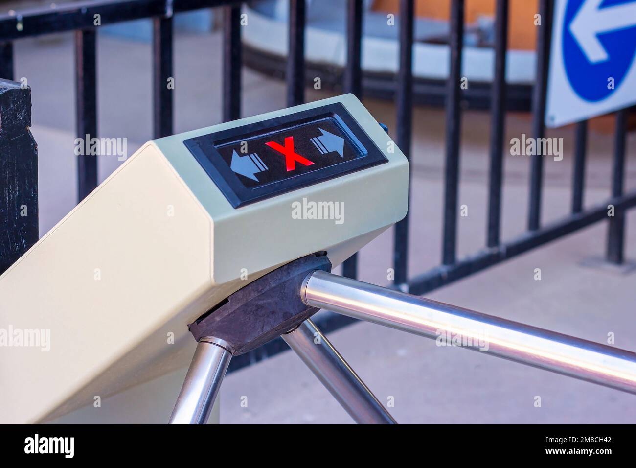 Modern automated metallic turnstile entrance system with stop sign on it means closed pass. Forbidden access for enter and exit through the tourniquet Stock Photo