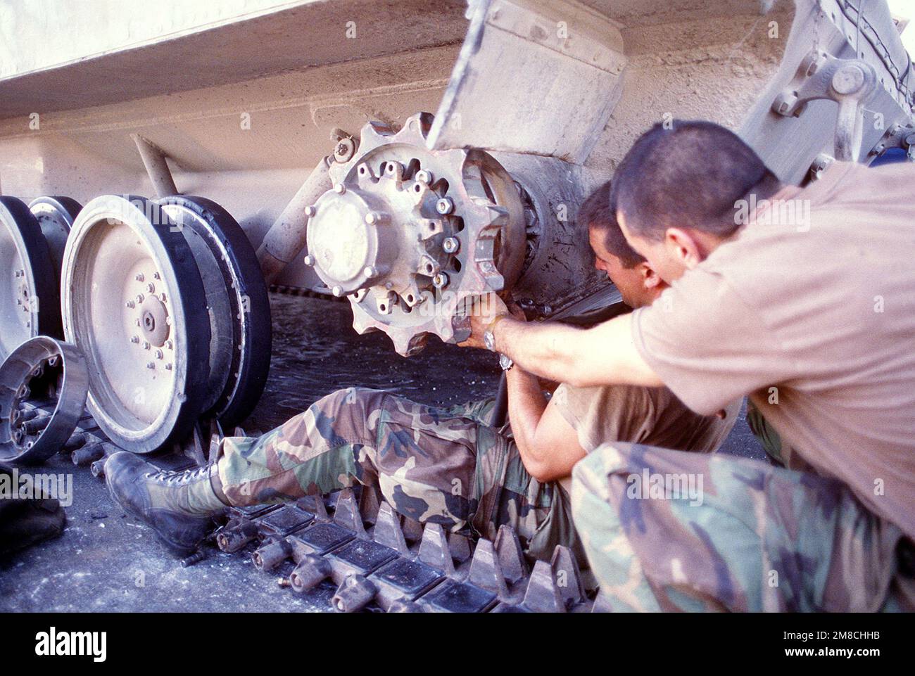 Two members of the 82nd Airborne Division repair the left drive sprocket on an M-551 Sheridan light tank parked at the international airport following Operation Just Cause, the U.S. invasion of Panama. Subject Operation/Series: JUST CAUSE Base: Tocumen Country: Panama (PAN) Stock Photo