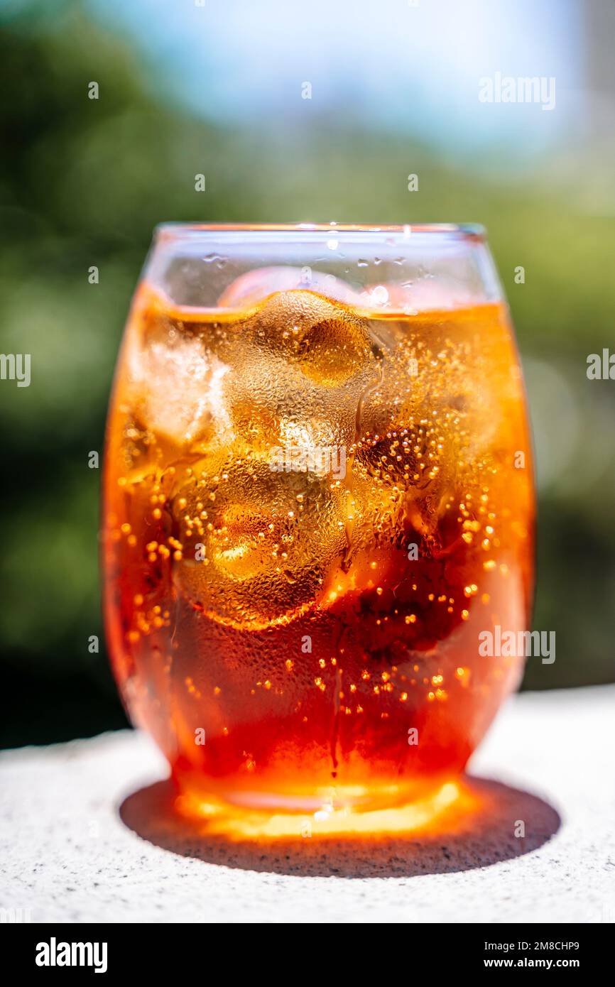 Cold cocktail. Summer soft drink with ice based on orange juice and syrup in a glass. High quality photo Stock Photo