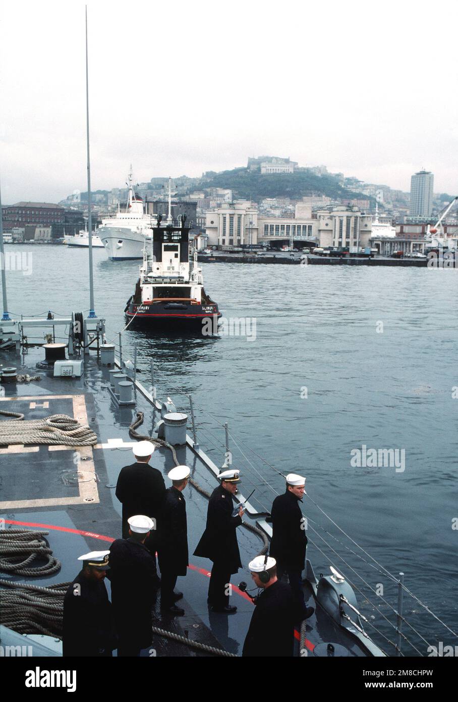 Officers and sailors stand by aboard the guided missile destroyer USS ...