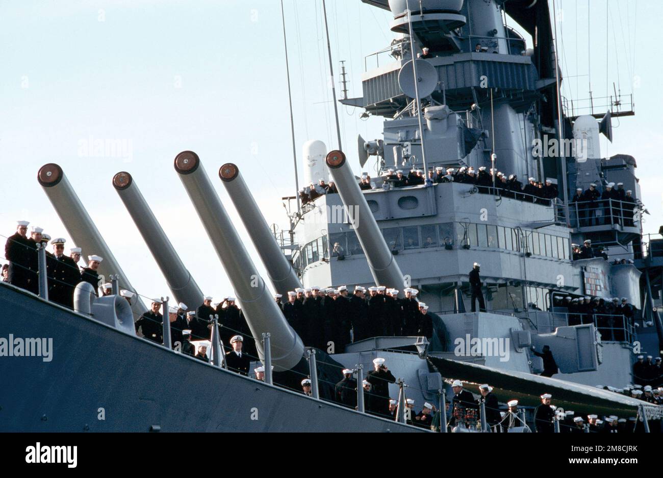 Crew members gather at the rails as the battleship USS IOWA (BB 61 ...