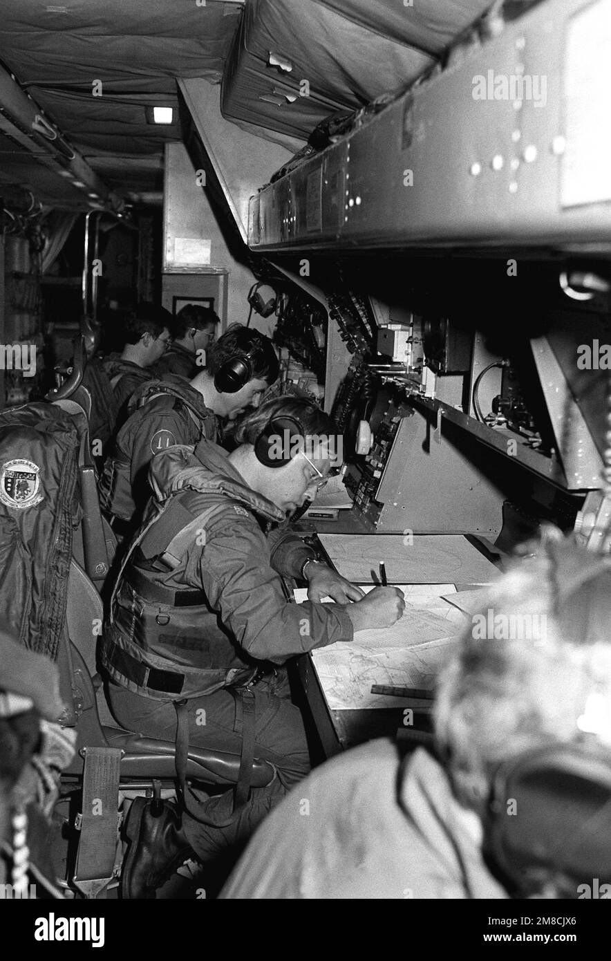 Technicians and systems operators in a Naval Air Reserve Patrol Squadron 64 (VP-64) P-3 Orion aircraft record and plot during active duty training. State: Hawaii (HI) Country: United States Of America (USA) Stock Photo