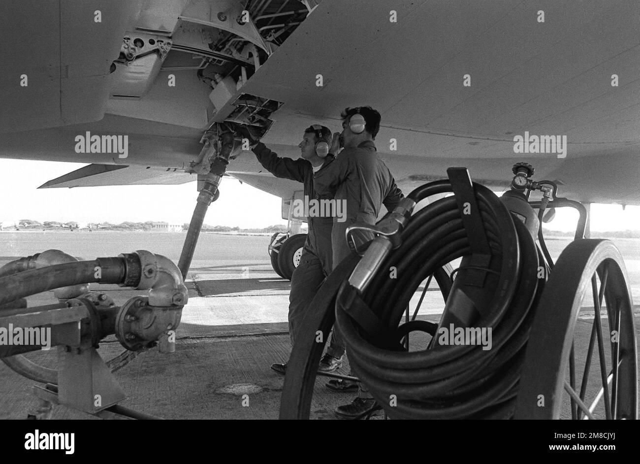 Ground crew members refuel a Naval Air Reserve Patrol Squadron 64 (VP-64) P-3 Orion aircraft during active duty training. Base: Naval Air Station, Barbers Point State: Hawaii (HI) Country: United States Of America (USA) Stock Photo