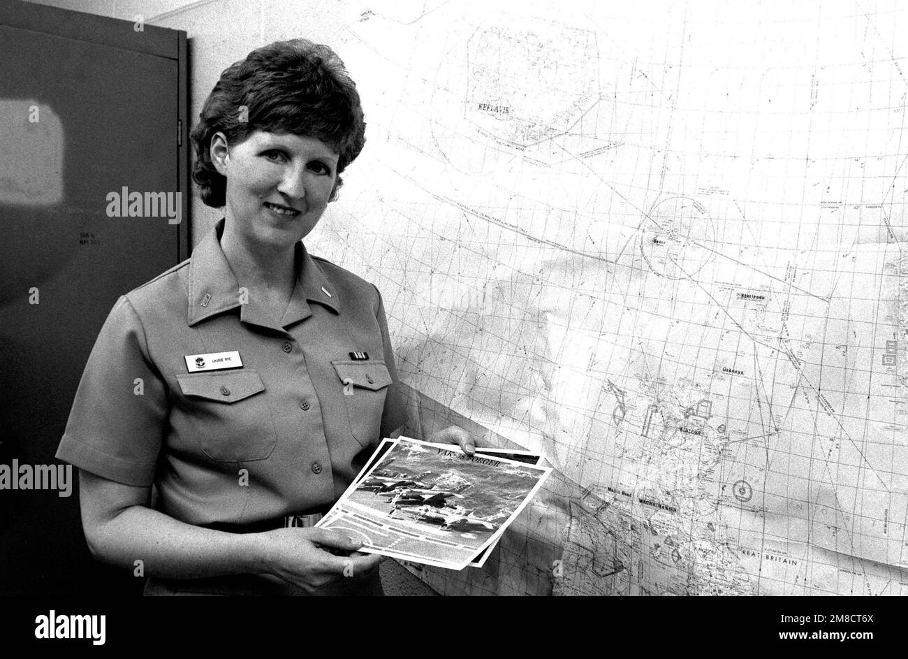 Lieutenant Junior Grade (LTJG) Laurie Rye, an intelligence officer assigned to Patrol Squadron 56 (VP-56) displays a stack of aircraft recognition training photographs. Base: Naval Air Station, Jacksonville State: Florida (FL) Country: United States Of America (USA) Stock Photo