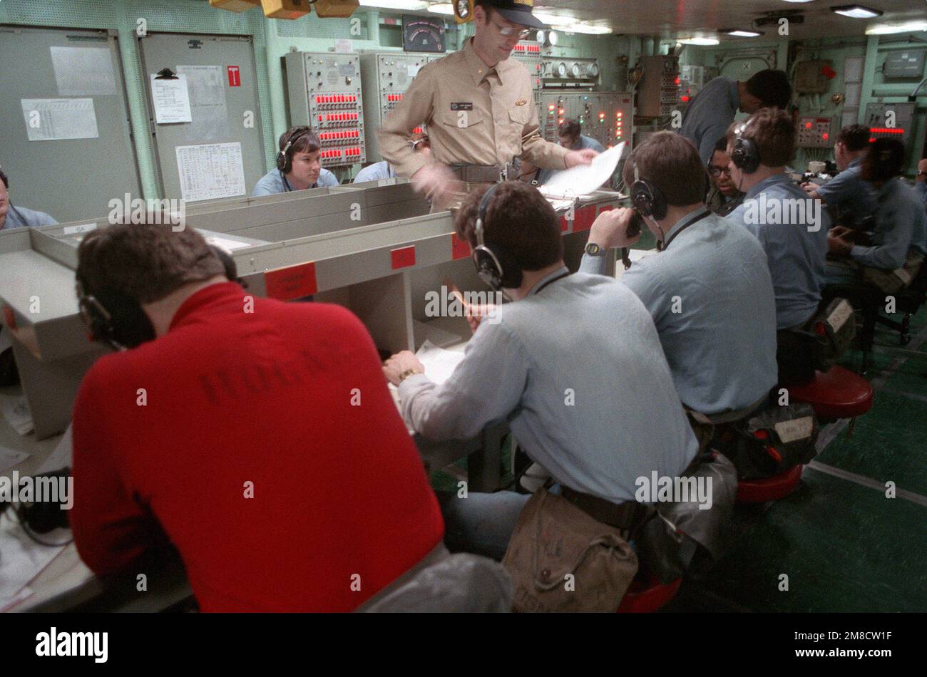 Damage control personnel monitor sound-powered telephones at their ...