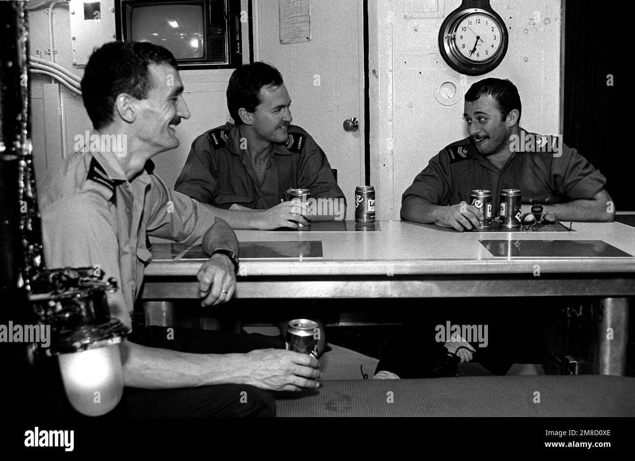 Off-duty sailors relax in the enlisted men's mess aboard the Canadian frigate HMCS MARGAREE (DDH 230) during FLEET EX 1-90. Subject Operation/Series: FLEET EX 1-90 Base: Hmcs Margaree (DDH 230) Country: Atlantic Ocean (AOC) Stock Photo