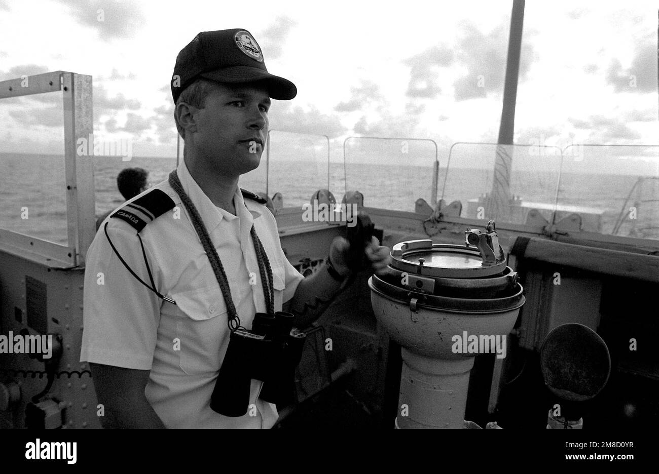 An officer stands watch on the open-air bridge aboard the Canadian frigate HMCS MARGAREE (DDH 230) during FLEET EX 1-90. Subject Operation/Series: FLEET EX 1-90 Base: Hmcs Margaree (DDH 230) Country: Atlantic Ocean (AOC) Stock Photo