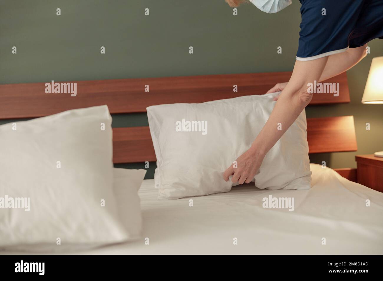 Cleaning lady doing housekeeping and making bed in hotel room. Cleaning service concept Stock