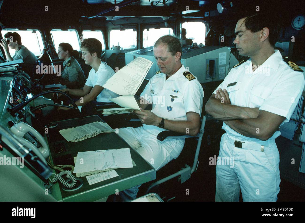 Dutch navy officers review paperwork on the bridge of the frigate HR MS CALLENBURGH (F-808) during Fleet Ex 1-90. Subject Operation/Series: FLEET EX 1-90 Base: Hr Ms Callenburgh (F-808) Country: Atlantic Ocean (AOC) Stock Photo