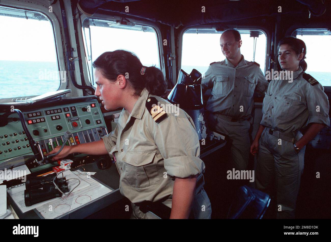 LT Trommelen, officer of the watch, monitors equipment on the bridge of the Dutch navy frigate HR MS CALLENBURGH (F-808) as other officers stand by during Fleet Ex 1-90. Subject Operation/Series: FLEET EX 1-90 Base: Hr Ms Callenburgh (F-808) Country: Atlantic Ocean (AOC) Stock Photo