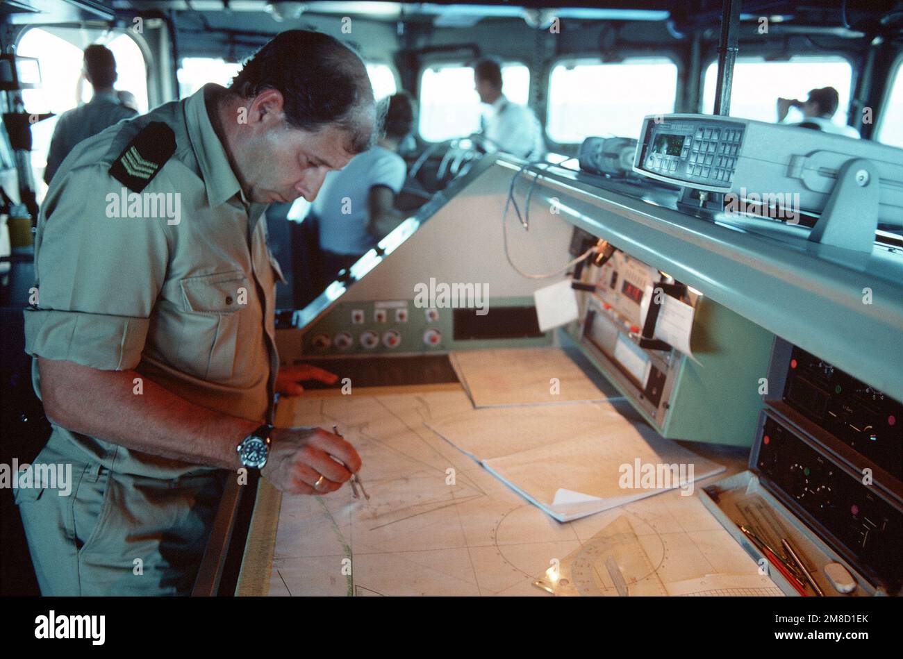A Dutch navy officer plots coordinates on a grid on the bridge of the frigate HR MS CALLENBURGH (F-808) during Fleet Ex 1-90. Subject Operation/Series: FLEET EX 1-90 Base: Hr Ms Callenburgh (F-808) Country: Atlantic Ocean (AOC) Stock Photo