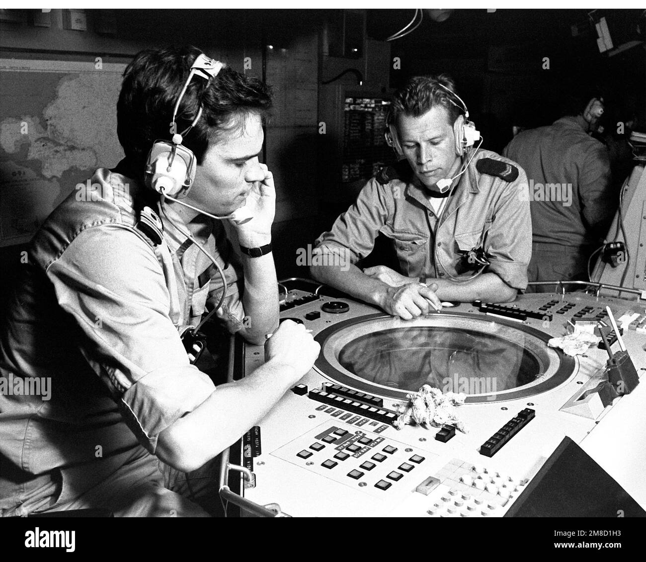 An officer and an enlisted man monitor a radar screen in the air picture station aboard the Dutch frigate HR MS CALLENBURGH (F-808) during FLEET EX 1-90. Subject Operation/Series: FLEET EX 1-90 Country: Atlantic Ocean (AOC) Stock Photo