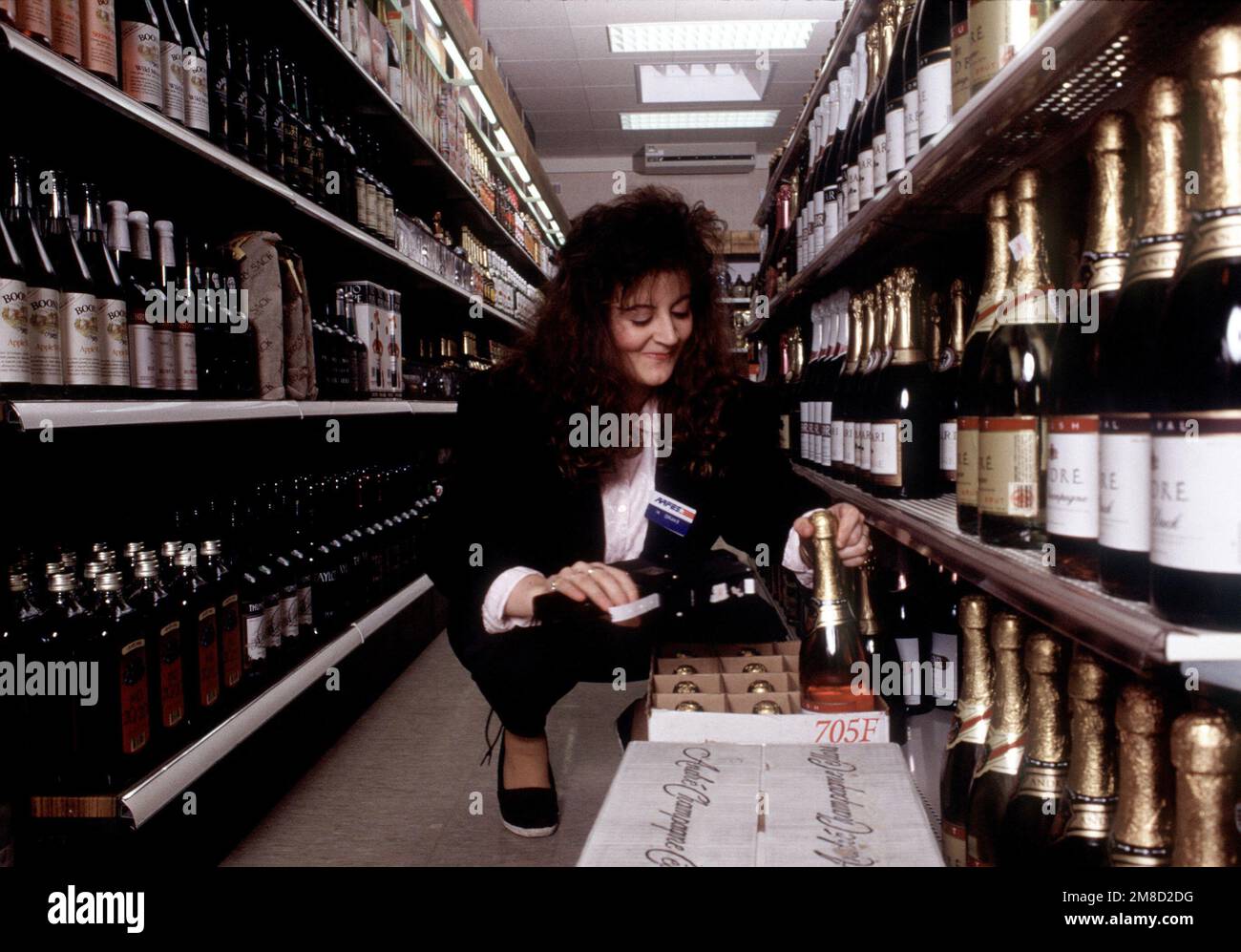 An employee stocks shelves at the Truman Plaza liquor store, an Army