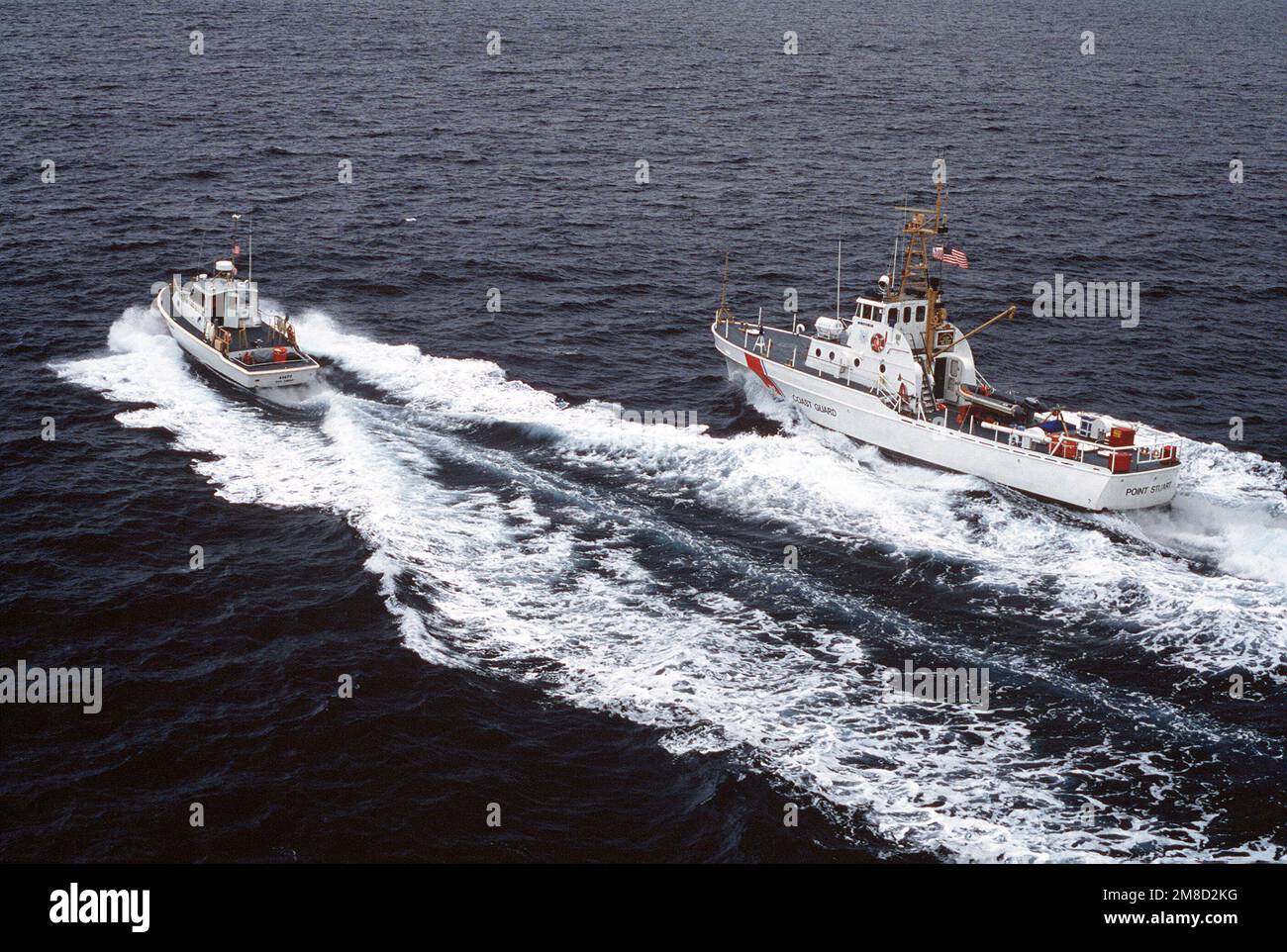 A 41-foot US Coast Guard patrol boat passes the patrol boat USCGC POINT STUART (WPB 82358) during a routine mission. Country: Unknown Stock Photo