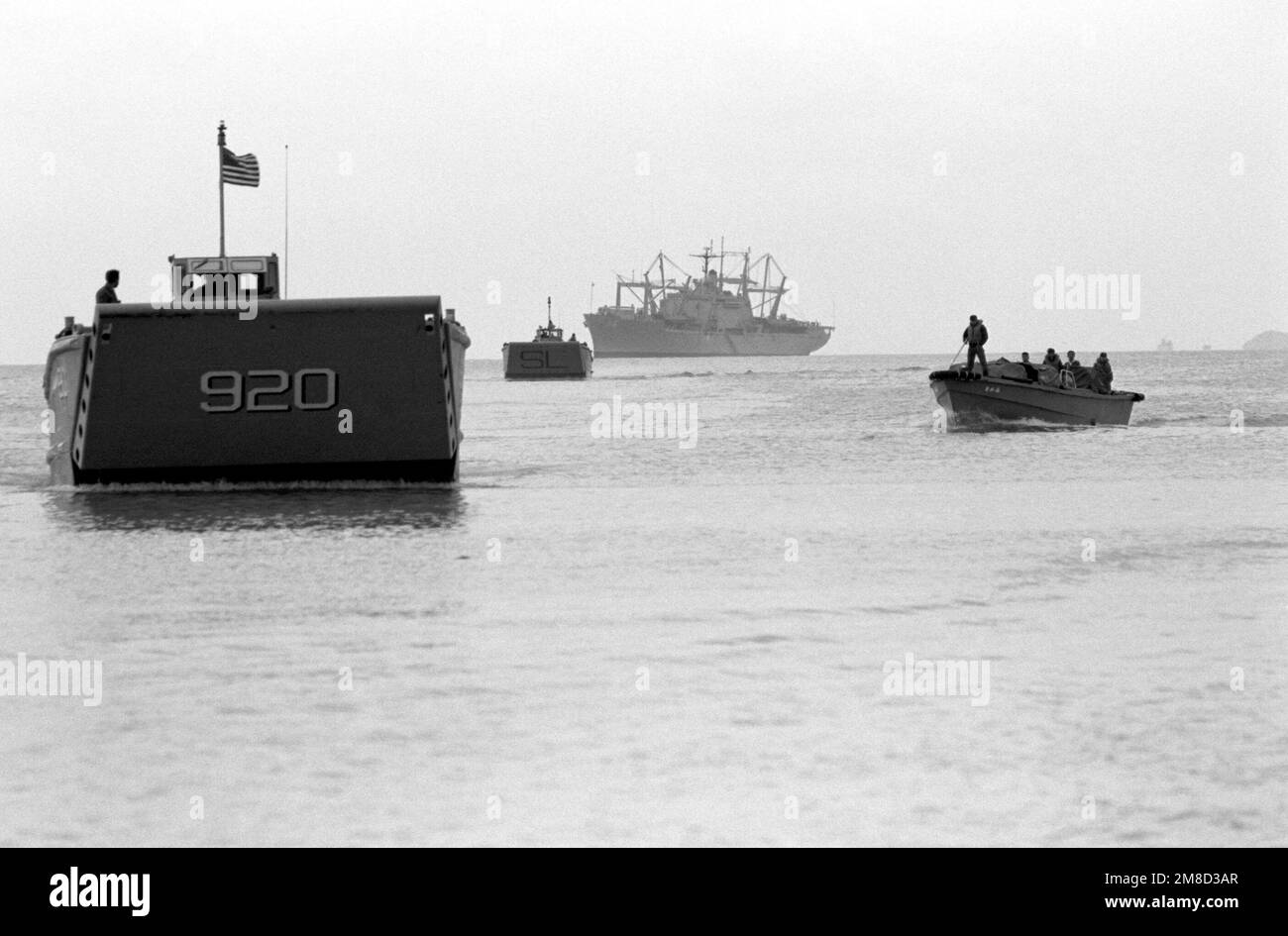 Two LCM-8 mechanized landing craft head for shore to pick up Marine Corps vehicles and equipment that will be loaded aboard amphibious ships and transported to South Korea for use in the combined South Korean/U.S. exercise Team Spirit '90. The amphibious cargo ship USS ST. LOUIS (LKA-116) is in the background. Subject Operation/Series: TEAM SPIRIT '90 State: Okinawa Country: Japan (JPN) Stock Photo