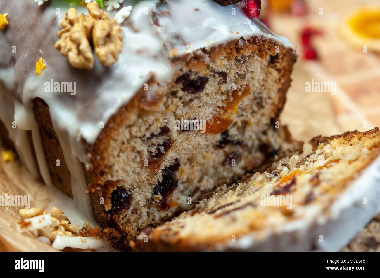 Christmas stollen with candied fruit and dried fruits on parchment. Stollen traditional German