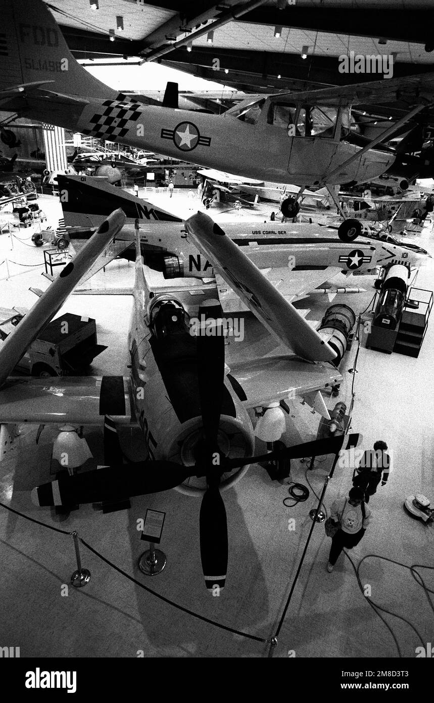 Visitors to the US Naval Aviation Museum walk past an A1H Skyraider