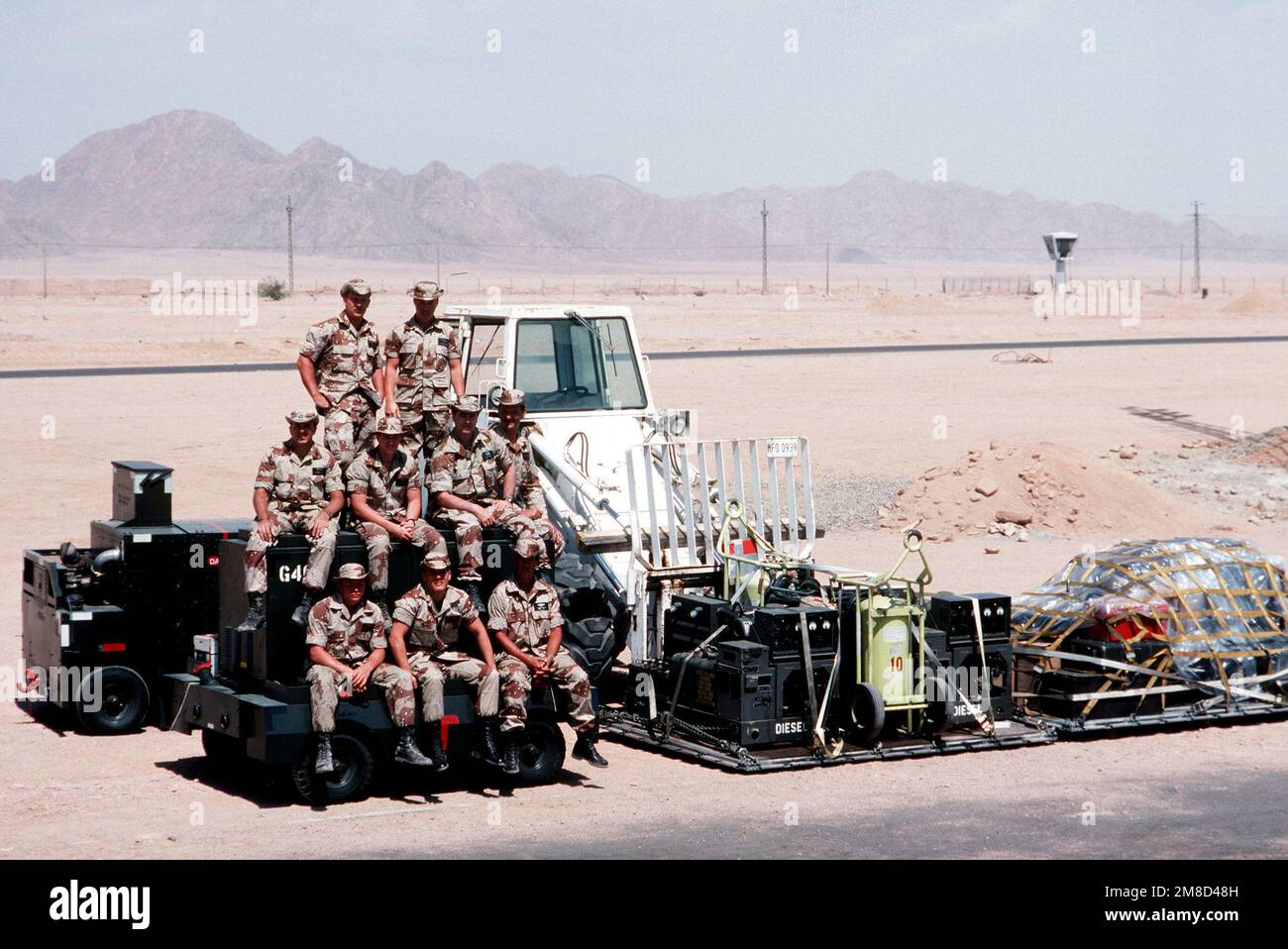 Airmen from the 435th Tactical Airlift Wing's airlift control element (ALCE) and the 4th Mobile Aerial Port Squadron gather for a group photograph at the Ras Nusrani airfield. The airmen are in Egypt to coordinate aircraft operations connected with the arrival and departure of United States forces serving with the Multinational Force and Observers (MFO) peacekeepers on the Sinai Peninsula. Base: Ras Nasrani Country: Egypt (EGY) Stock Photo