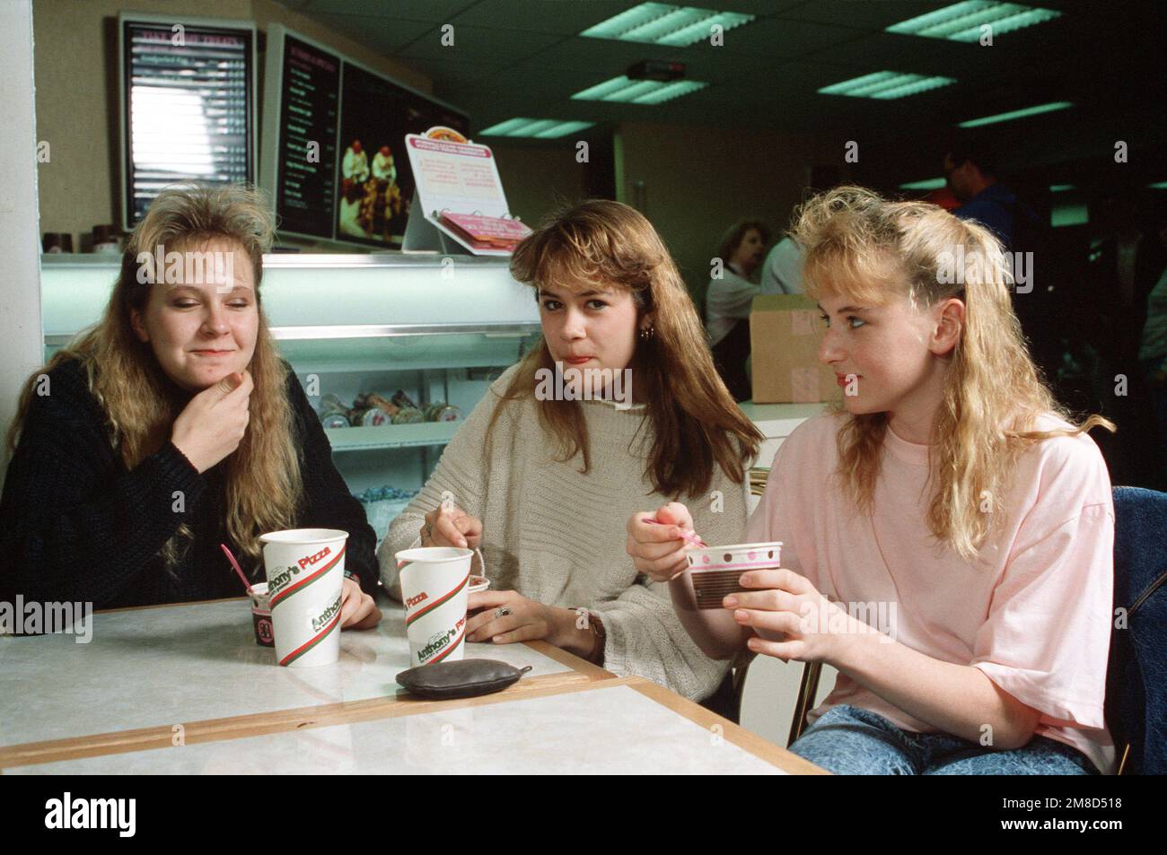 Teenagers enjoy ice cream at a concession in the food mall, part of the