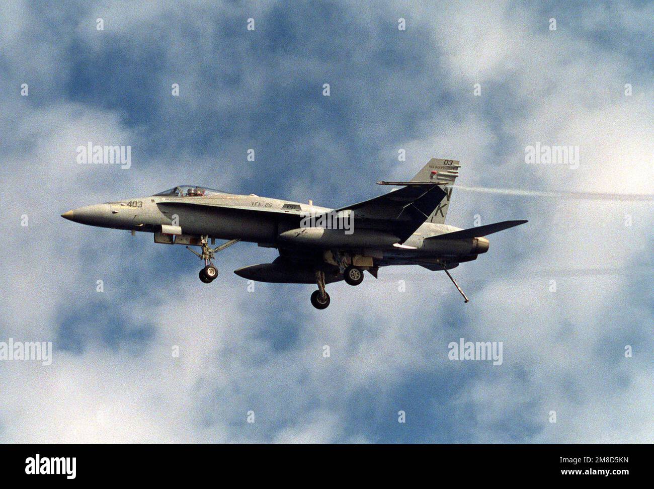 A Strike Fighter Squadron 25 (VFA-25) F/A-18C Hornet aircraft comes in ...