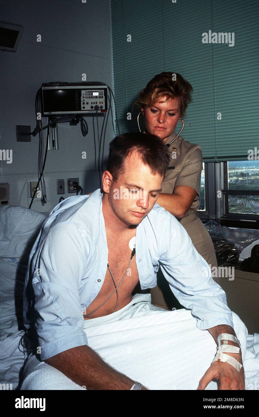 LT. Hoeger, a Navy doctor, listens to Harvey Mitchell's breathing in the  Intensive Care Unit of the U.S. Naval Hospital. State: Okinawa Country:  Japan (JPN Stock Photo - Alamy